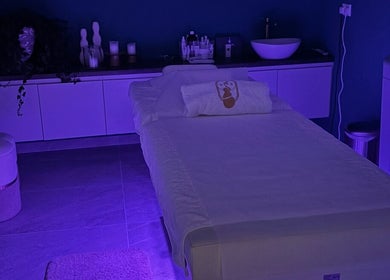 Relaxing treatment room at Velvet & Pearls Beauty Club in Limassol, Limassol, CY with soft purple lighting.