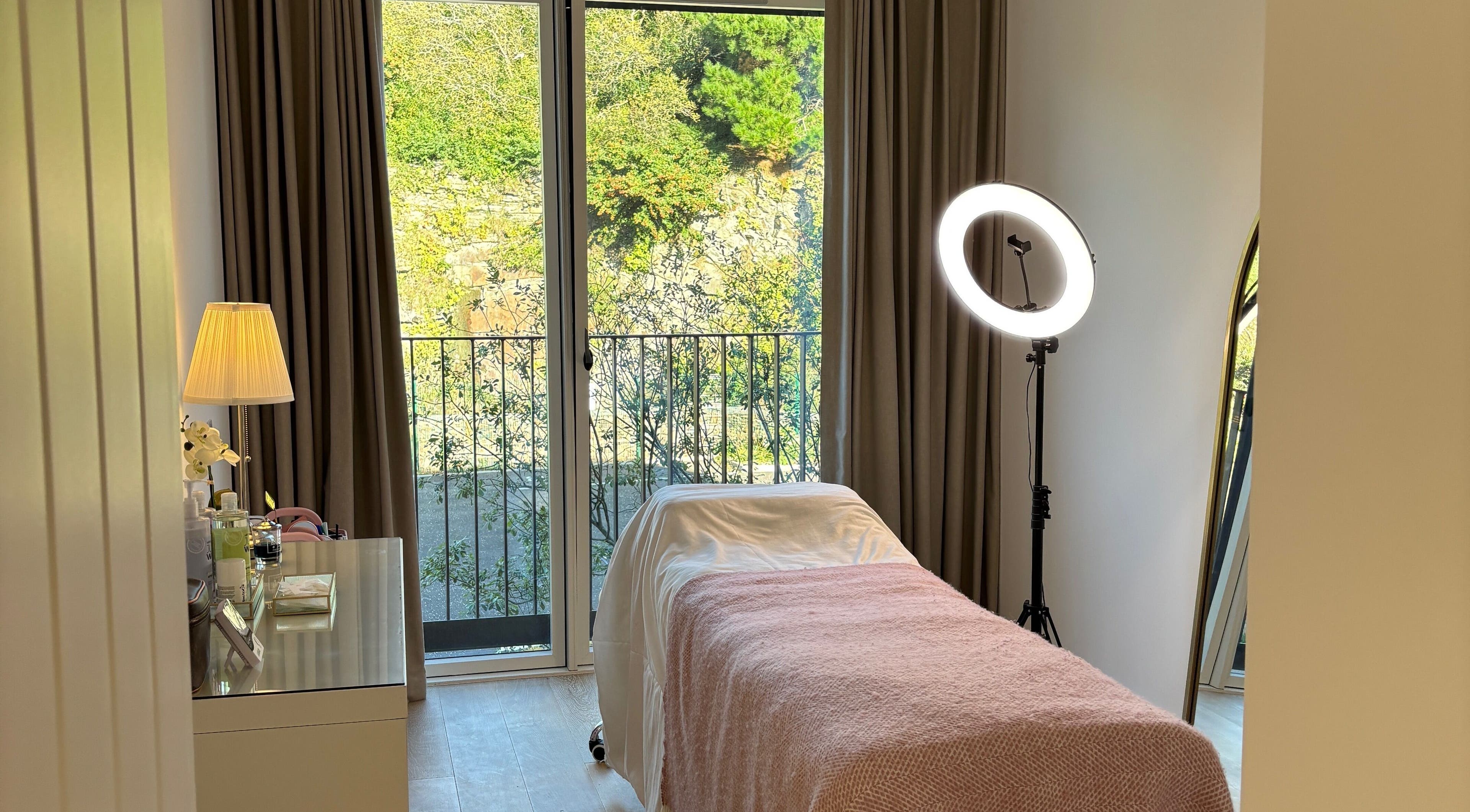Tranquil treatment room at Lashes By Izzy Rose in Hayle, GB, featuring a cozy bed and soft lighting.