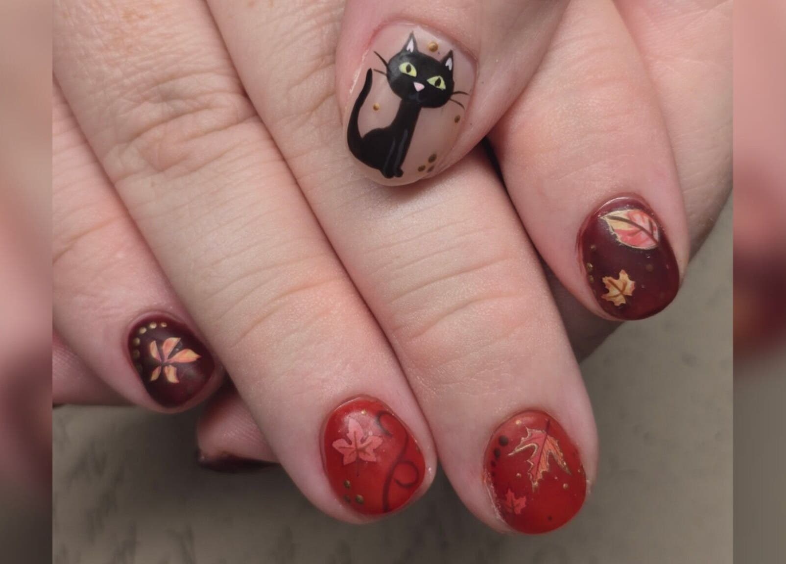 Festive autumn-themed nails with cat art at Sasco Nails in Henderson, Nevada, US.