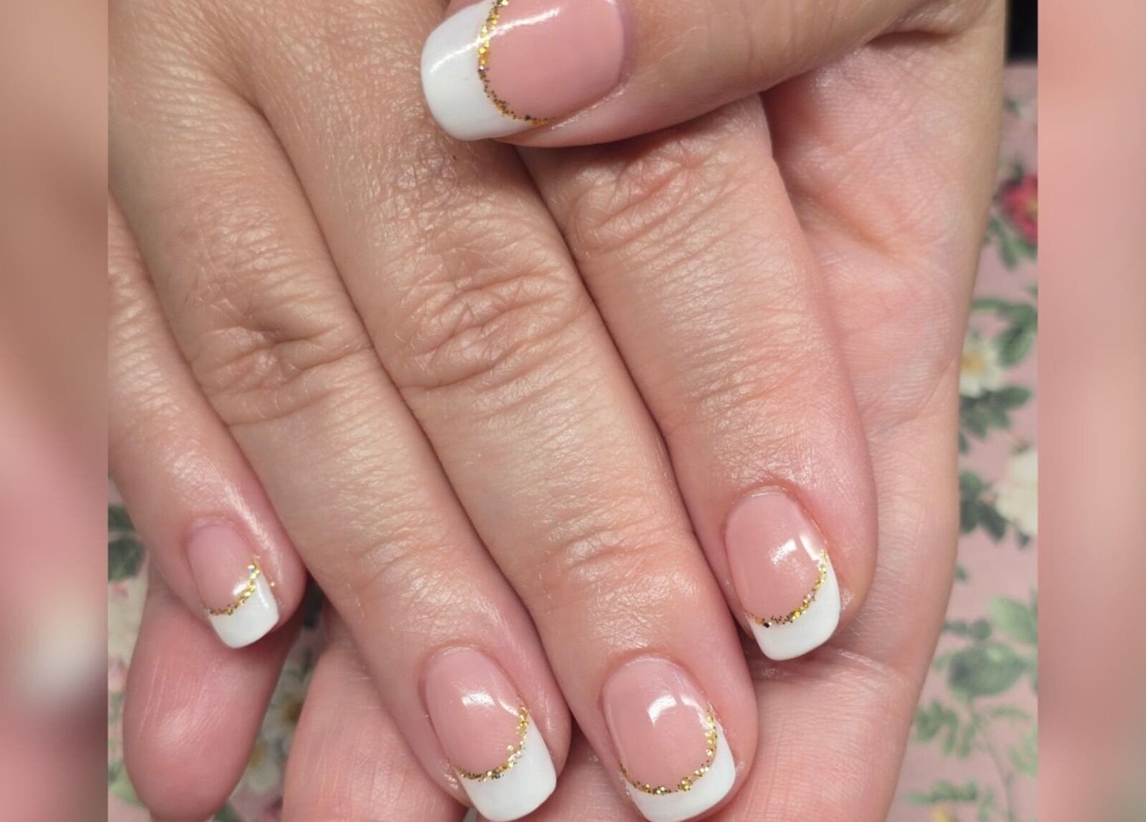 Elegant French tip nails with gold accents at Sasco Nails, Henderson, Nevada, US.