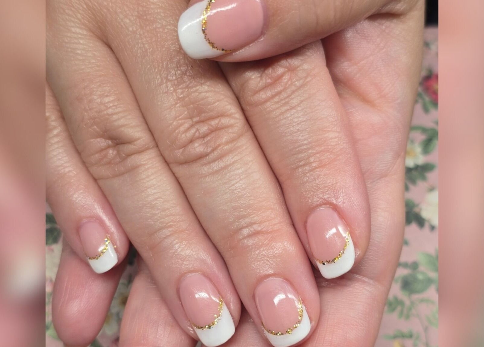 Elegant French tip nails with gold accents at Sasco Nails, Henderson, Nevada, US.