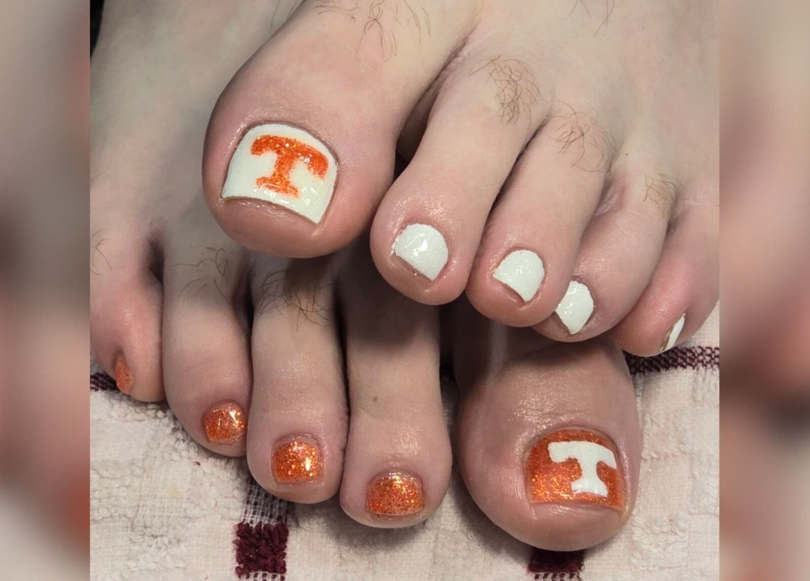 Vibrant orange and white pedicure at Sasco Nails in Henderson, Nevada, US.