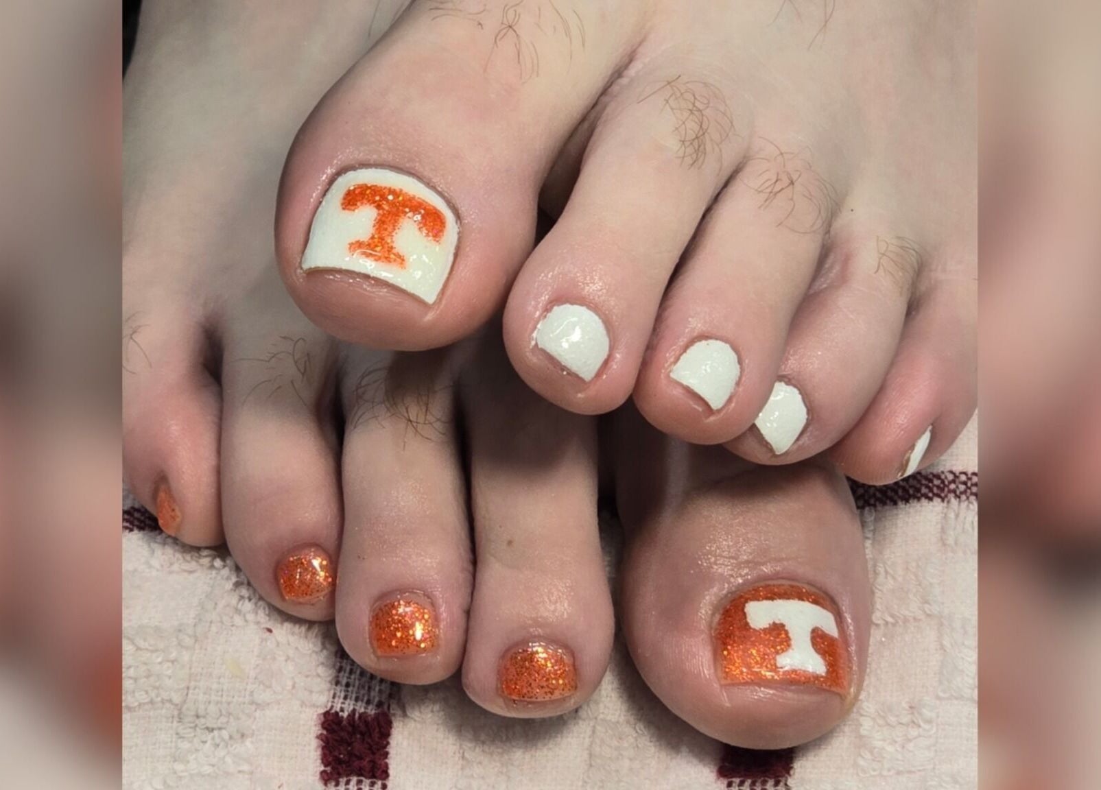 Vibrant orange and white pedicure at Sasco Nails in Henderson, Nevada, US.