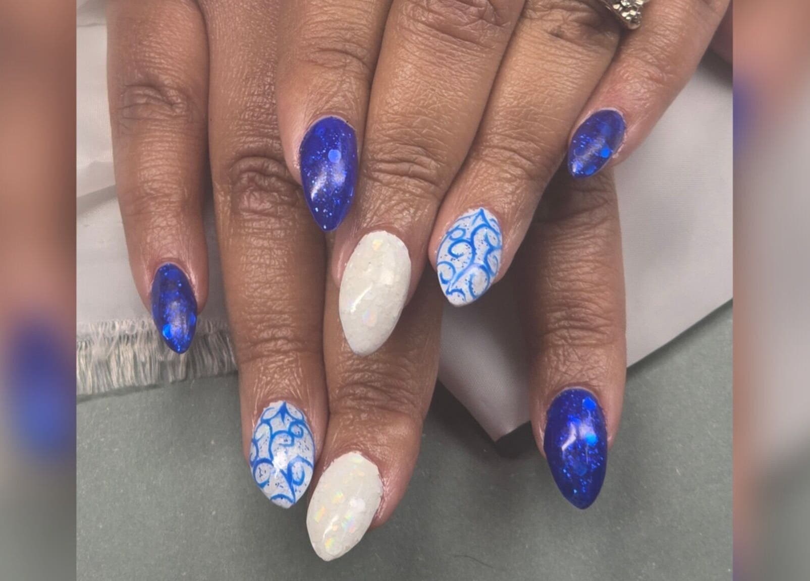 Unique galaxy and swirl nail art at Sasco Nails, Henderson, Nevada, US showcasing stunning blue and white designs.