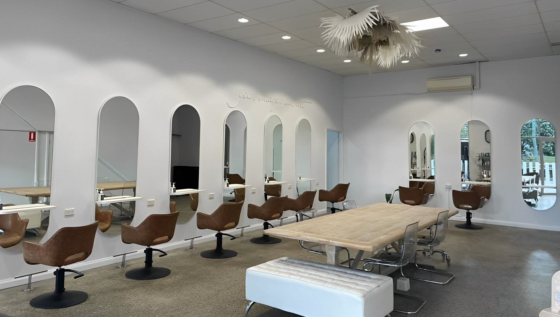 Interior of The Hairbar Studio in Castle Hill, New South Wales, AU showcases modern design with chic seating.