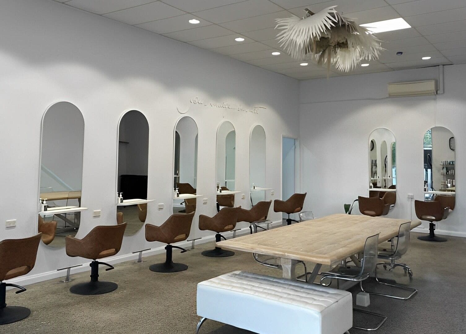 Interior of The Hairbar Studio in Castle Hill, New South Wales, AU showcases modern design with chic seating.