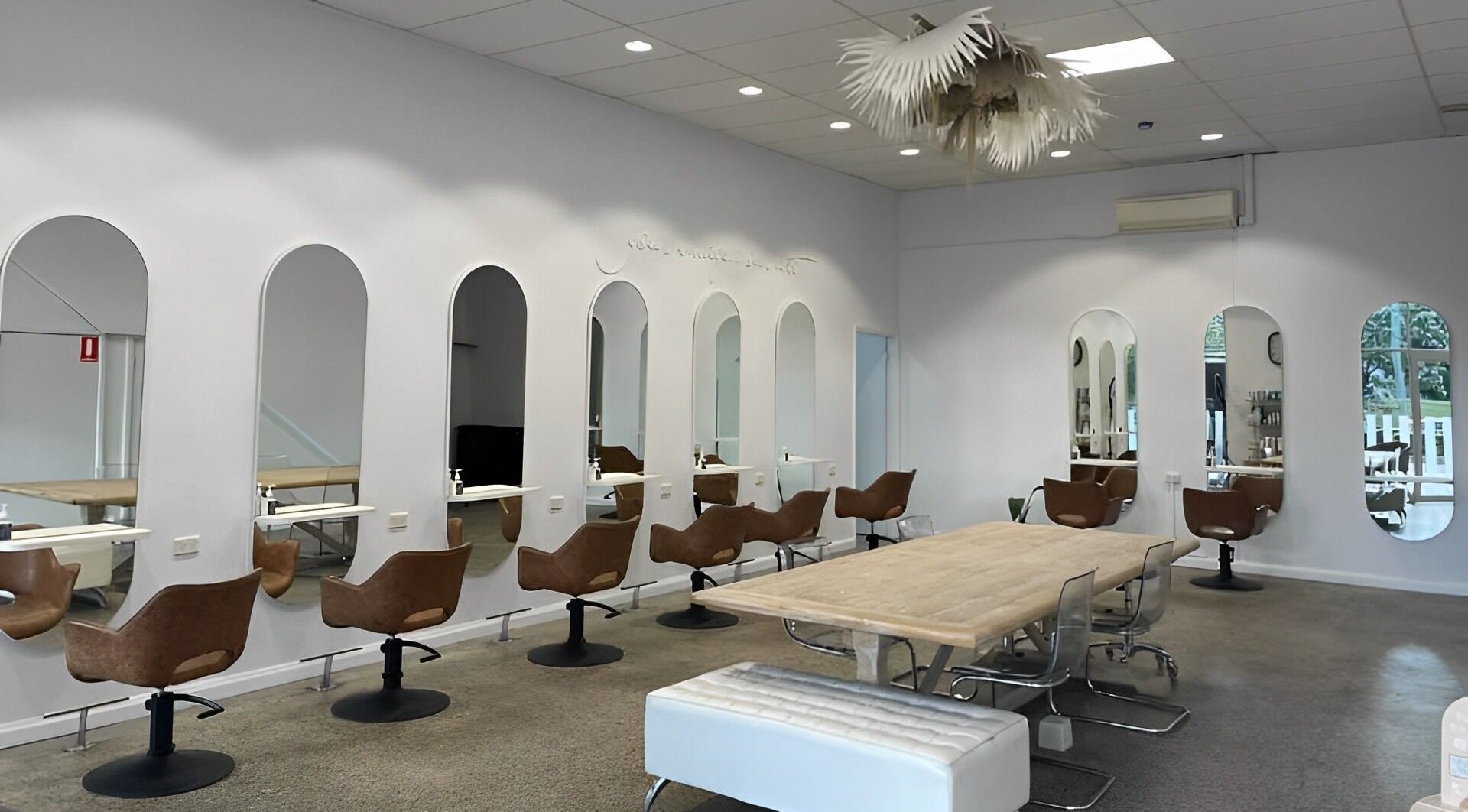 Interior of The Hairbar Studio in Castle Hill, New South Wales, AU showcases modern design with chic seating.