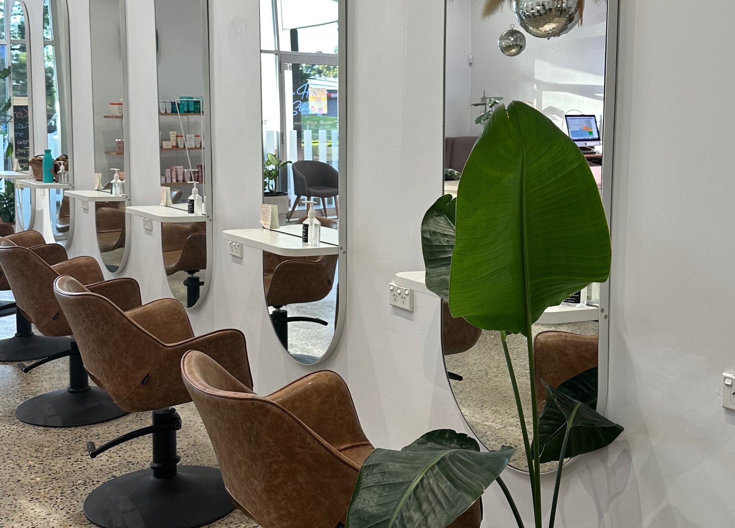 Modern salon seating at The Hairbar Studio, Castle Hill, New South Wales, AU, with sleek decor and stylish mirrors.