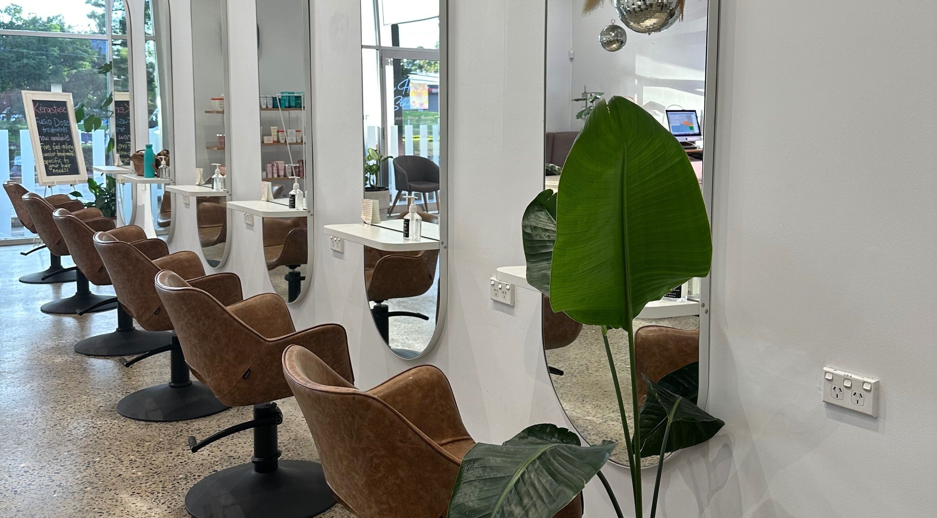 Modern salon seating at The Hairbar Studio, Castle Hill, New South Wales, AU, with sleek decor and stylish mirrors.
