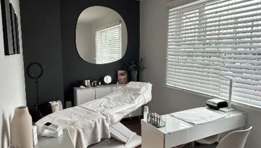 Spa room at Beauty By Freya MCR, Cheadle Hulme, England, GB with a treatment bed and serene decor.