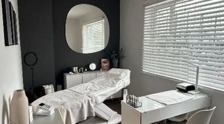 Spa room at Beauty By Freya MCR, Cheadle Hulme, England, GB with a treatment bed and serene decor.