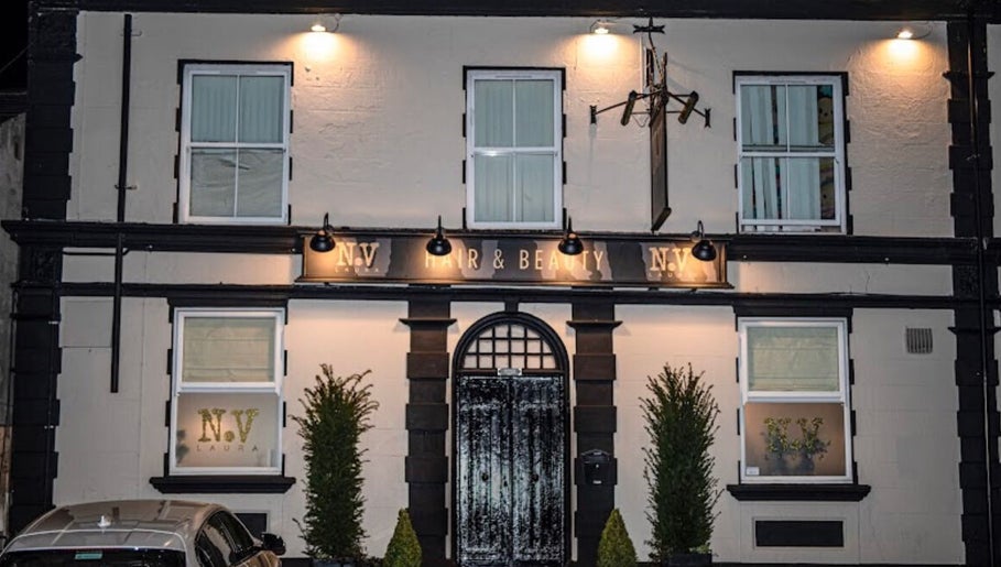 Front exterior of Billie Bebb Makeup Artist in Skelmersdale, England, GB, elegantly lit at night.