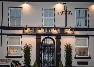 Front exterior of Billie Bebb Makeup Artist in Skelmersdale, England, GB, elegantly lit at night.