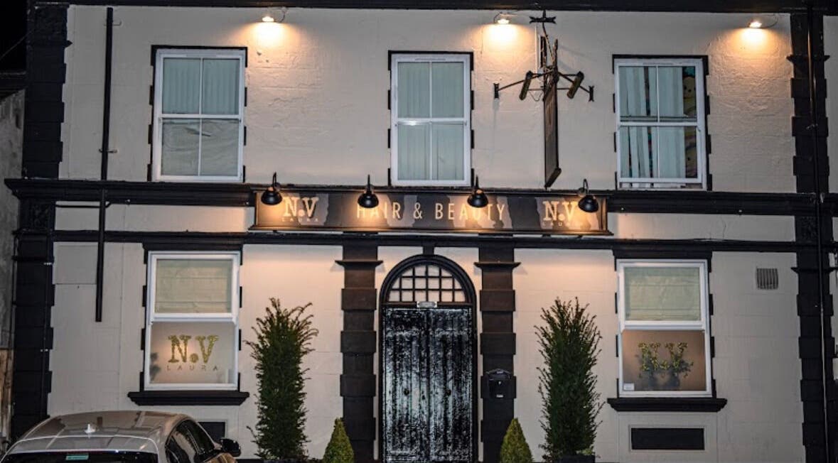 Front exterior of Billie Bebb Makeup Artist in Skelmersdale, England, GB, elegantly lit at night.