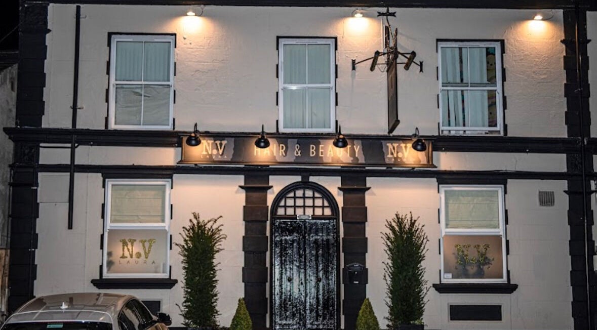 Front exterior of Billie Bebb Makeup Artist in Skelmersdale, England, GB, elegantly lit at night.