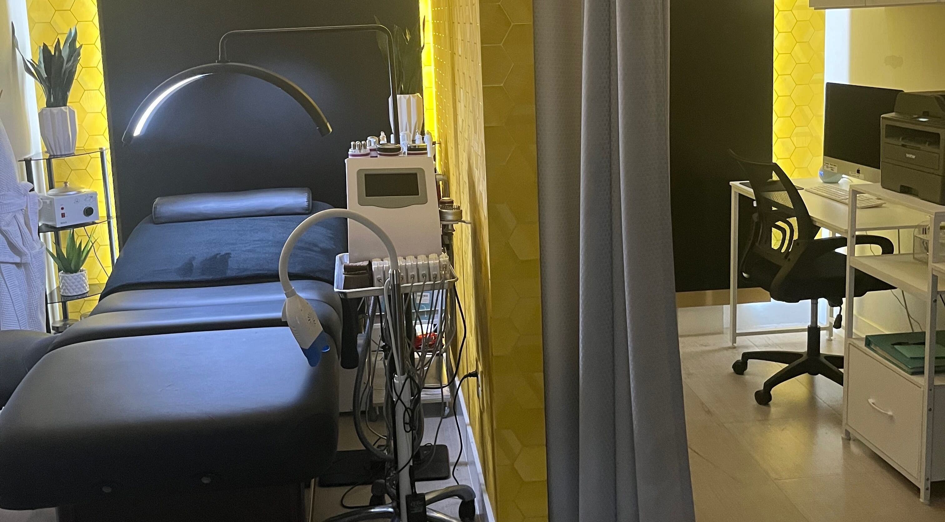 Spa treatment room at Adore Skin Studio Spa in San Tan Valley, Arizona, US, featuring sleek decor and a relaxing bed.