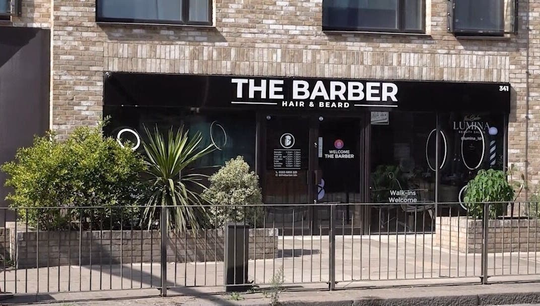 The Barber entrance in London, England, GB, showcasing a modern exterior with inviting signage.