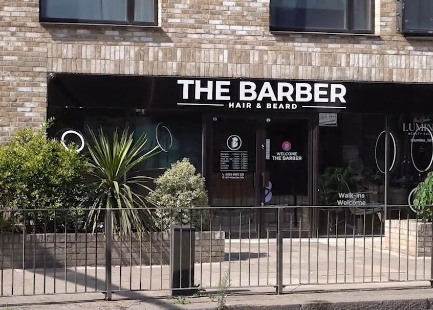 The Barber entrance in London, England, GB, showcasing a modern exterior with inviting signage.