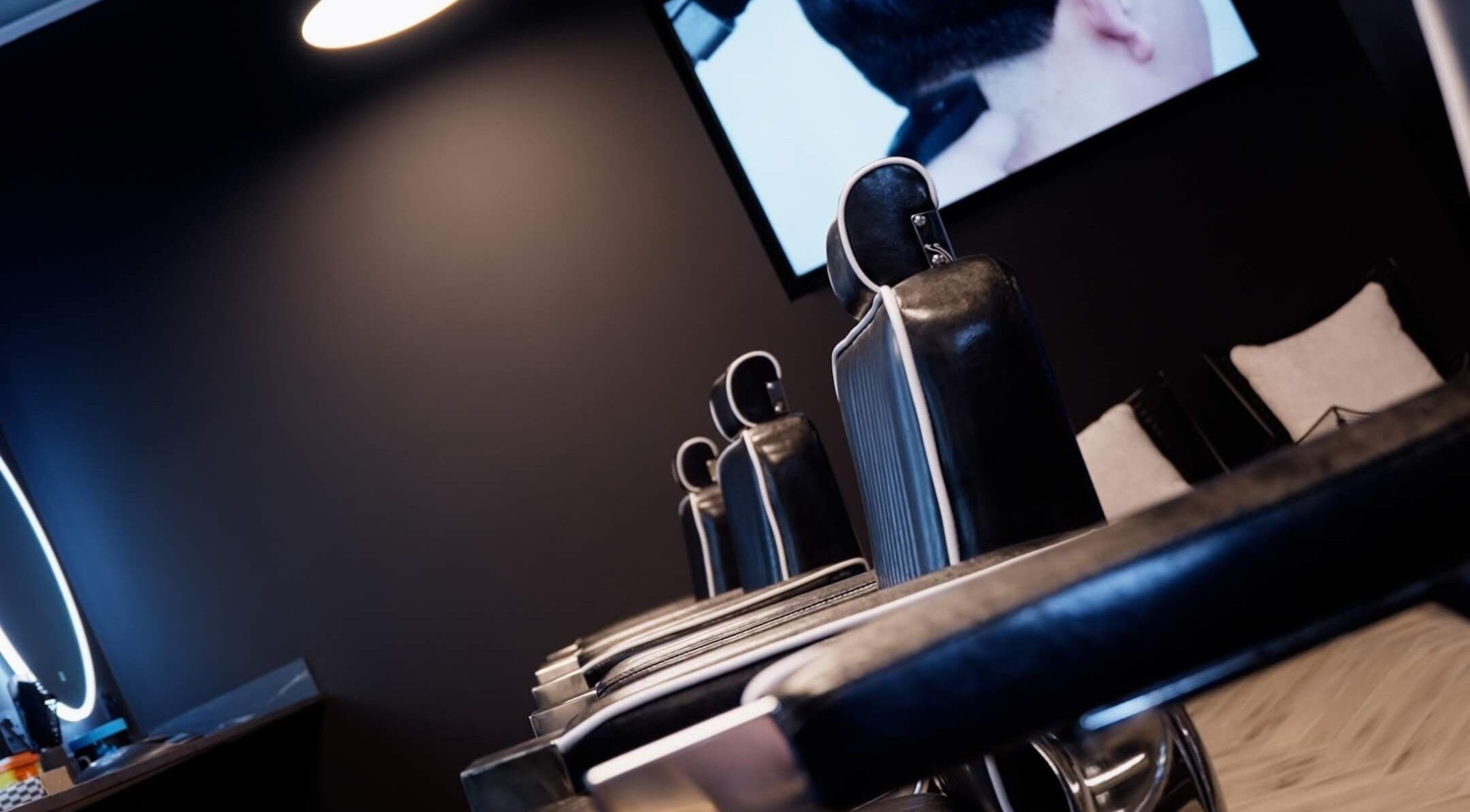 Sleek black barber chairs at The Barber, London, England, GB, offering stylish grooming services.
