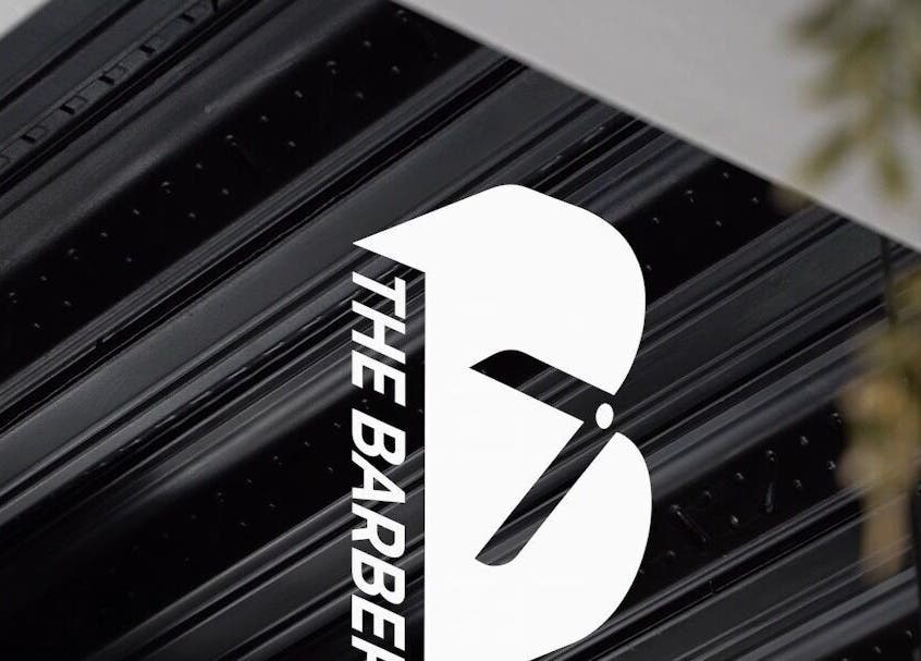 The Barber shop sign with bold black and white design in London, England, GB.