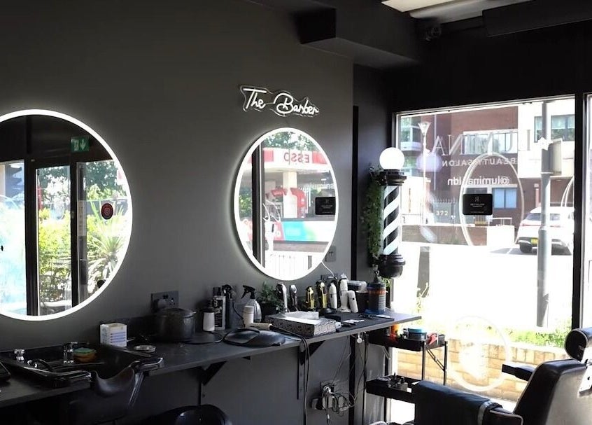 The Barber's stylish interior with mirrors and chairs in London, England, GB, ideal for grooming and relaxation.