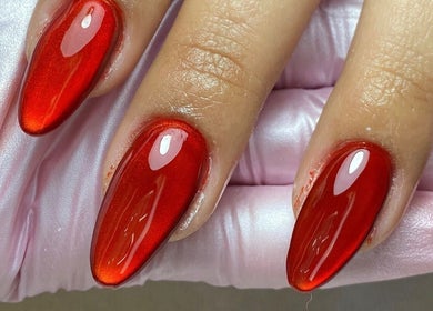 Uñas con esmalte rojo metálico en Âme Atelier Beauty, Chihuahua, Chihuahua, MX.