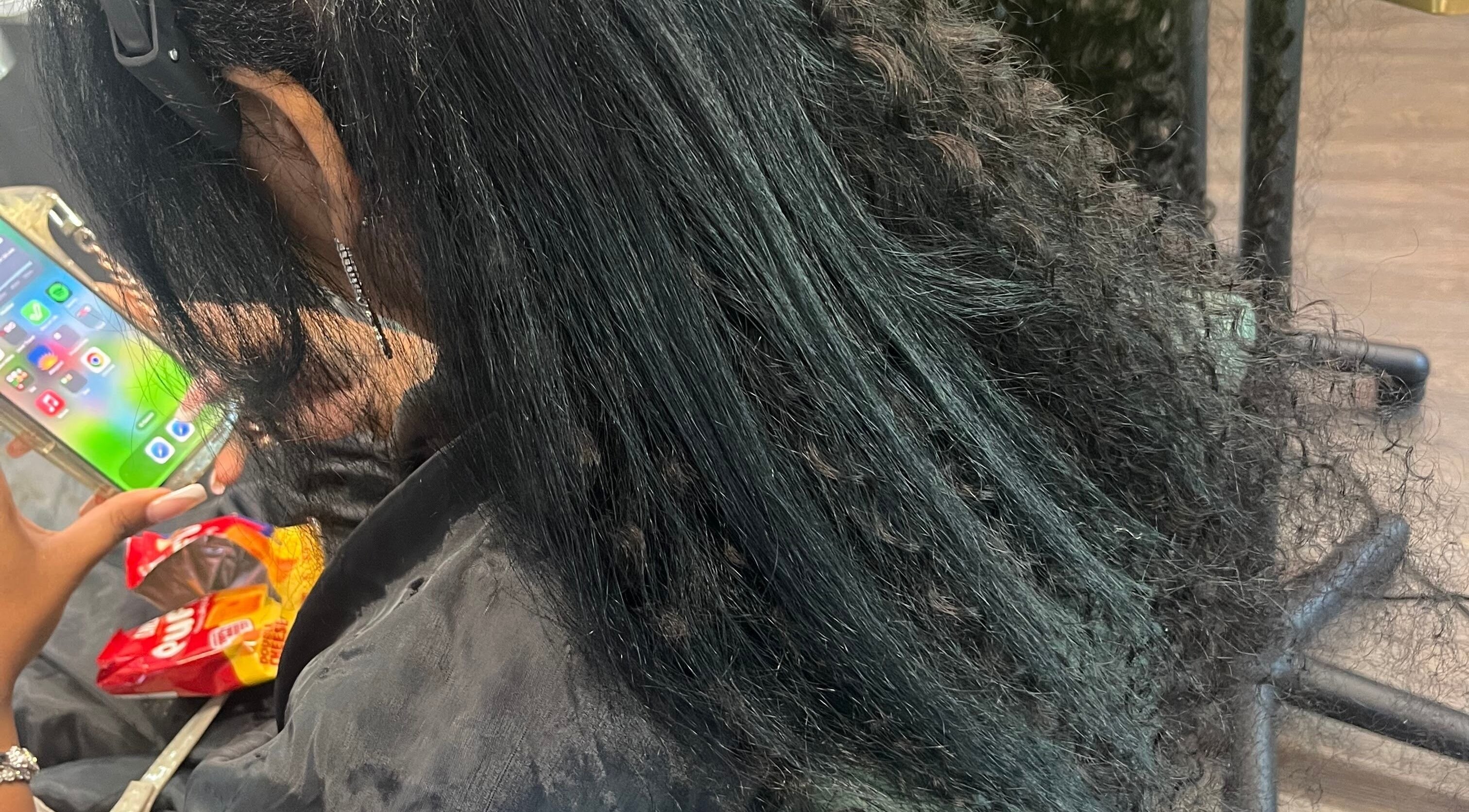 Client receives sleek hairstyling at Celine’s Hair, Lighthouse Point, Florida, US, showcasing shiny, straight hair.