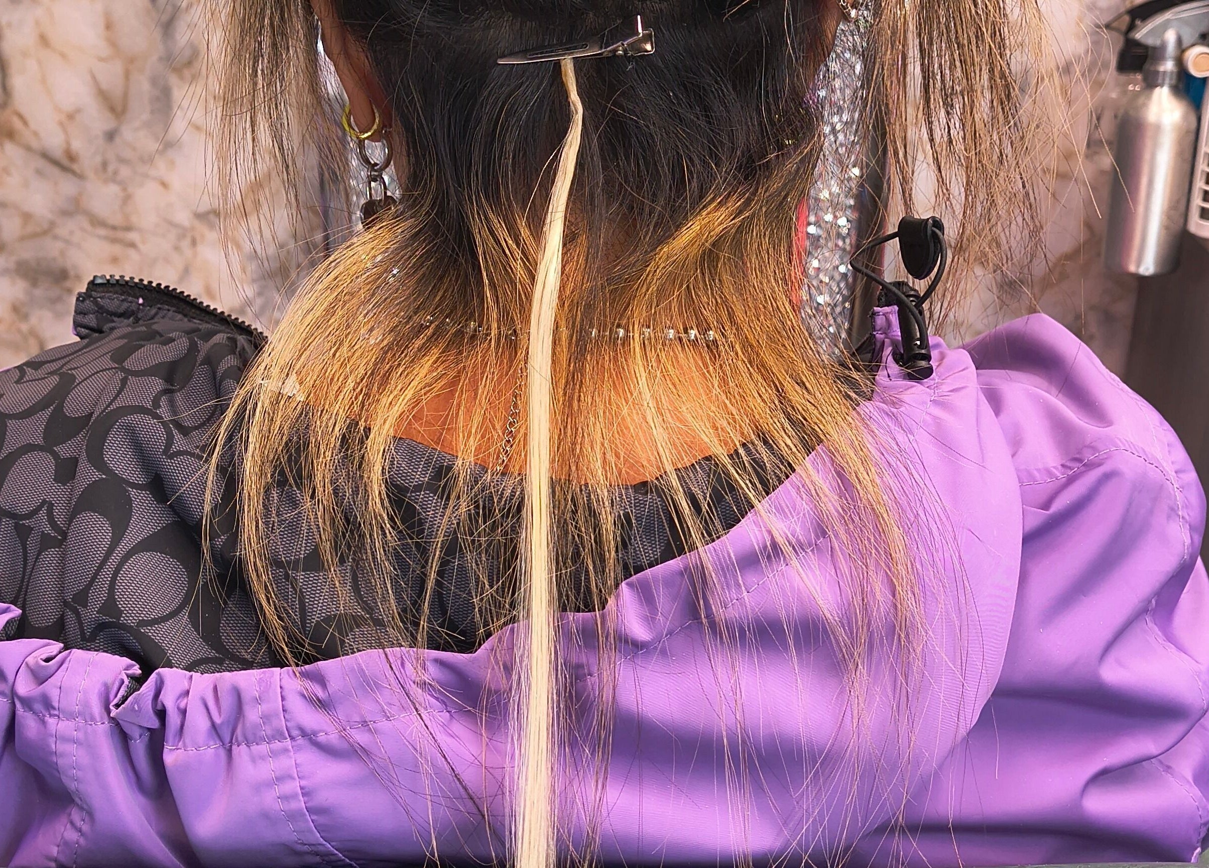 Hair extensions application in progress at Celine’s Hair, Lighthouse Point, Florida, US.