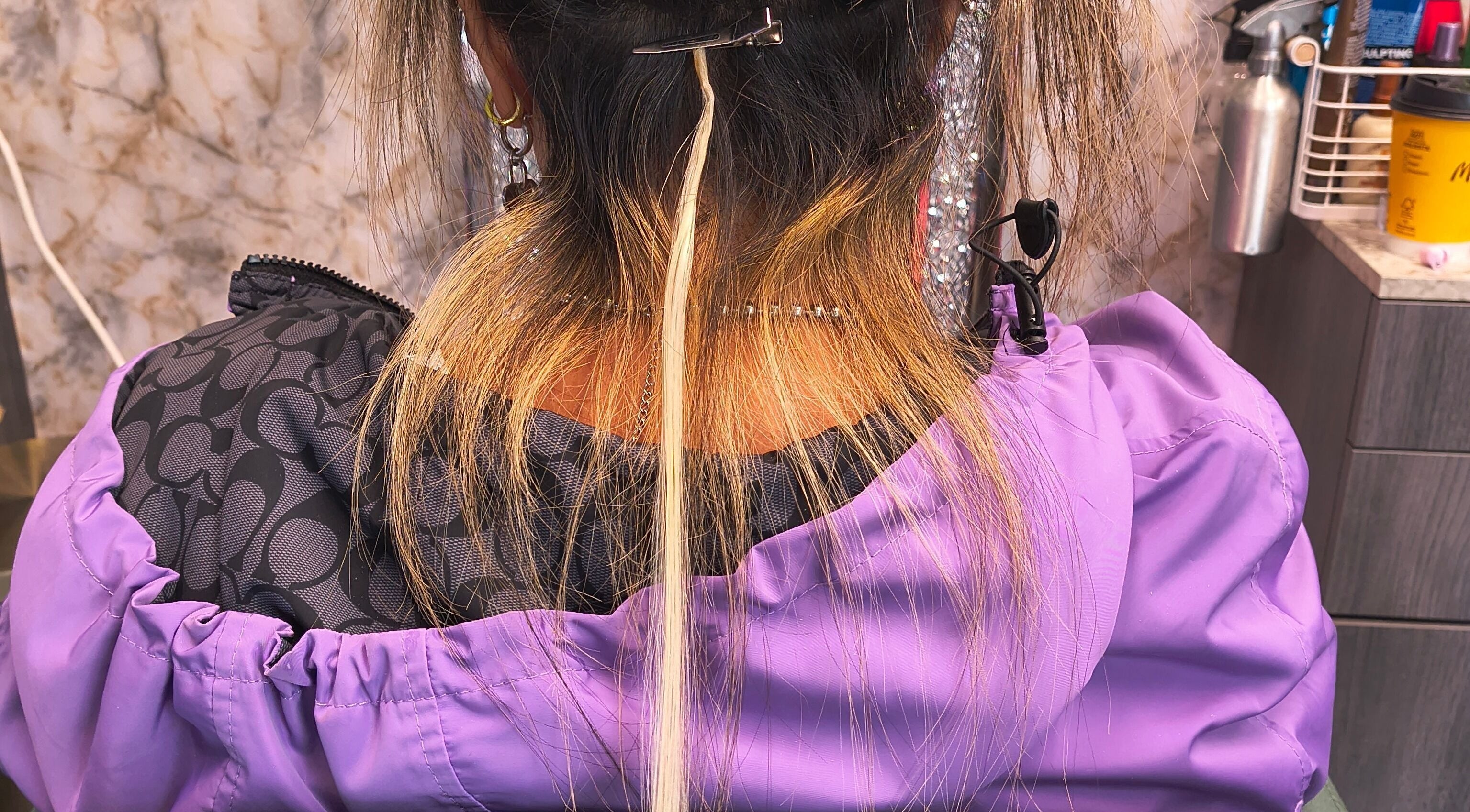 Hair extensions application in progress at Celine’s Hair, Lighthouse Point, Florida, US.