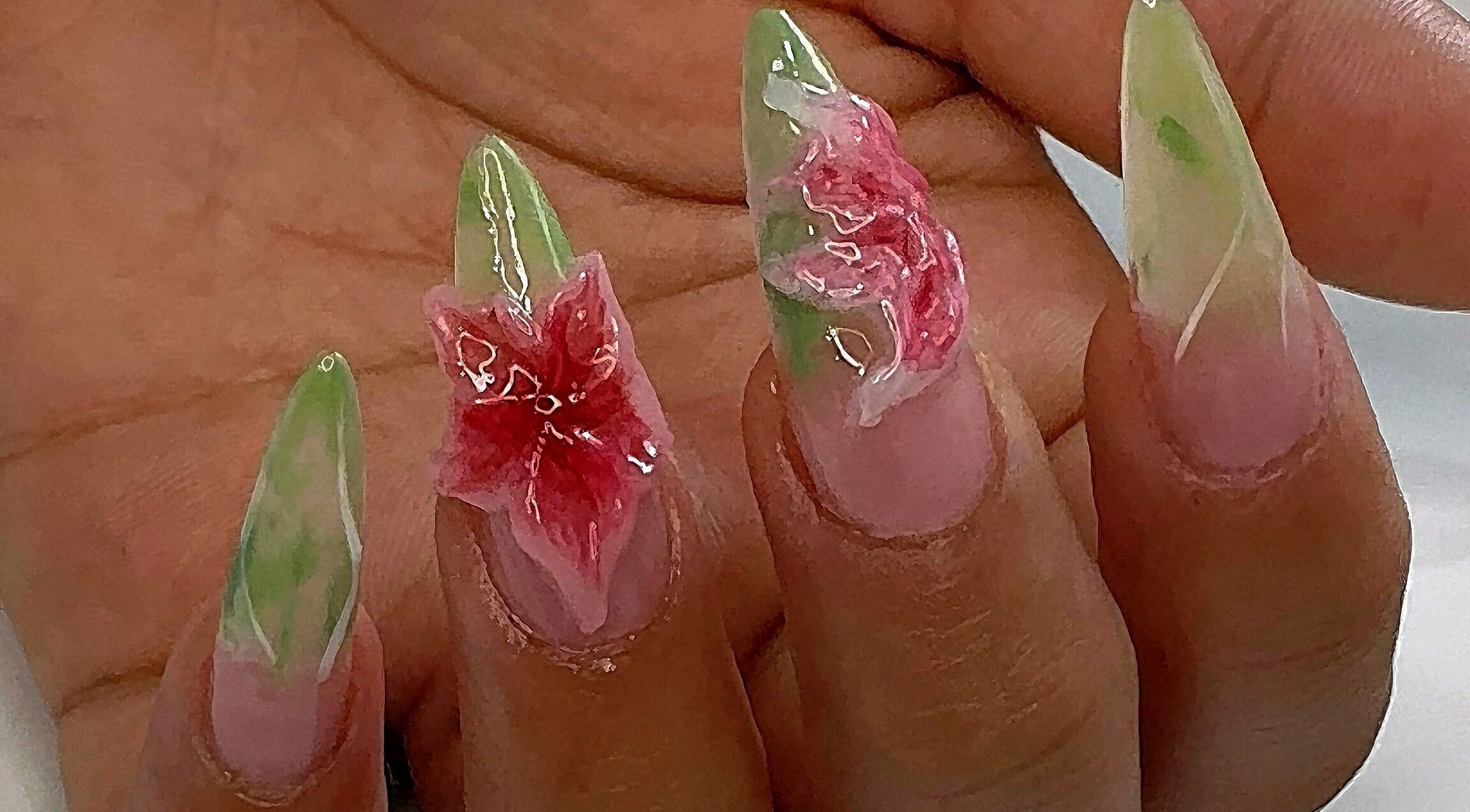 Delicate floral nail art from AK Nails in Thornton, New South Wales, AU, showcasing green and pink accents.