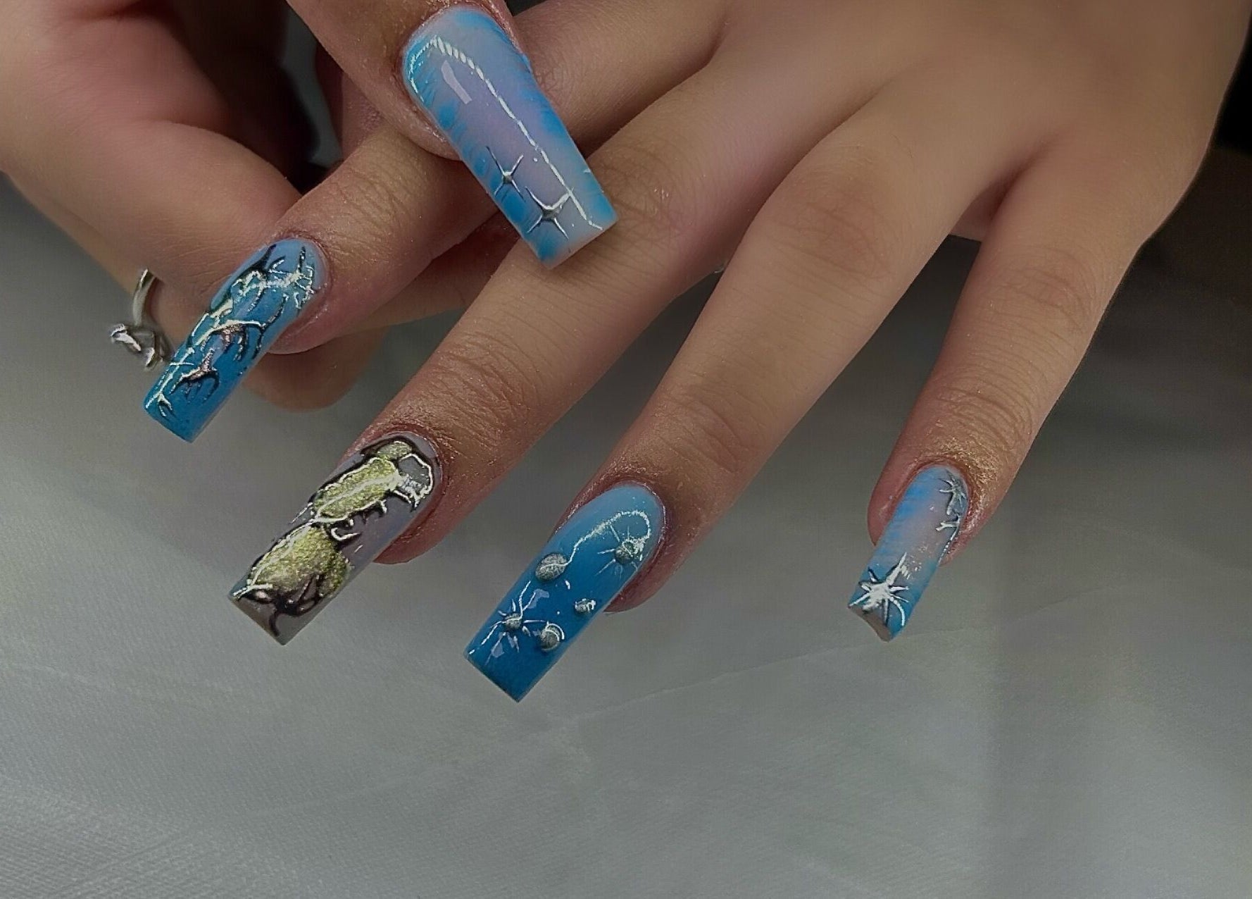 Detailed blue-themed nail art designed at AK Nails, Thornton, New South Wales, AU.