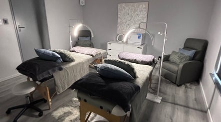 Double massage room at Exhale Massage & Beauty Spa, Cape Town, Western Cape, ZA with plush bedding and soft lighting.