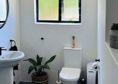 Elegant bathroom at Exhale Massage & Beauty Spa in Cape Town, Western Cape, ZA, featuring plants and modern decor.