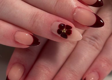 Elegant floral nail design by Nails By Cee in Brookvale, New South Wales, AU showcasing red french tips.