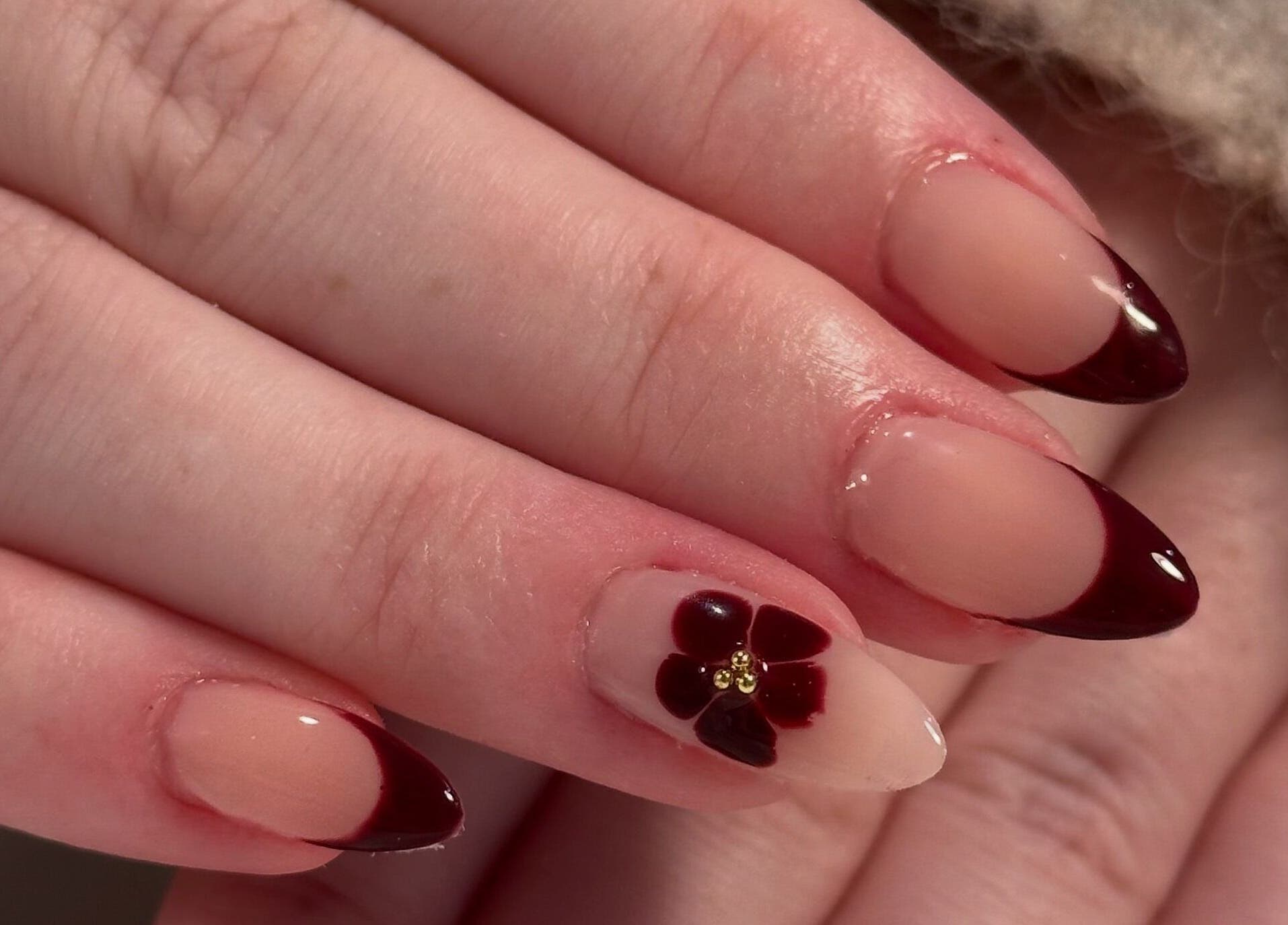 Elegant nail design with dark tips and floral art by Nails By Cee, Brookvale, New South Wales, AU.