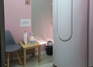 Private treatment room at The Glam Lab, Hartbeespoort, North West, ZA, featuring sauna pod and chair.