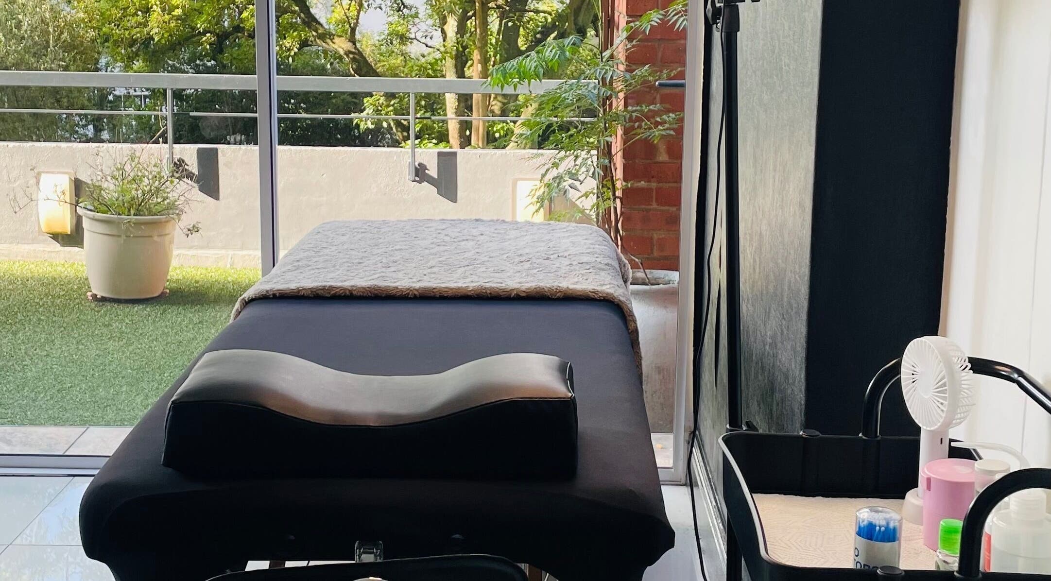 Relaxing treatment area at Lauren Ashley Eyelash Extensions, Pretoria, Gauteng, ZA, with serene outdoor view.
