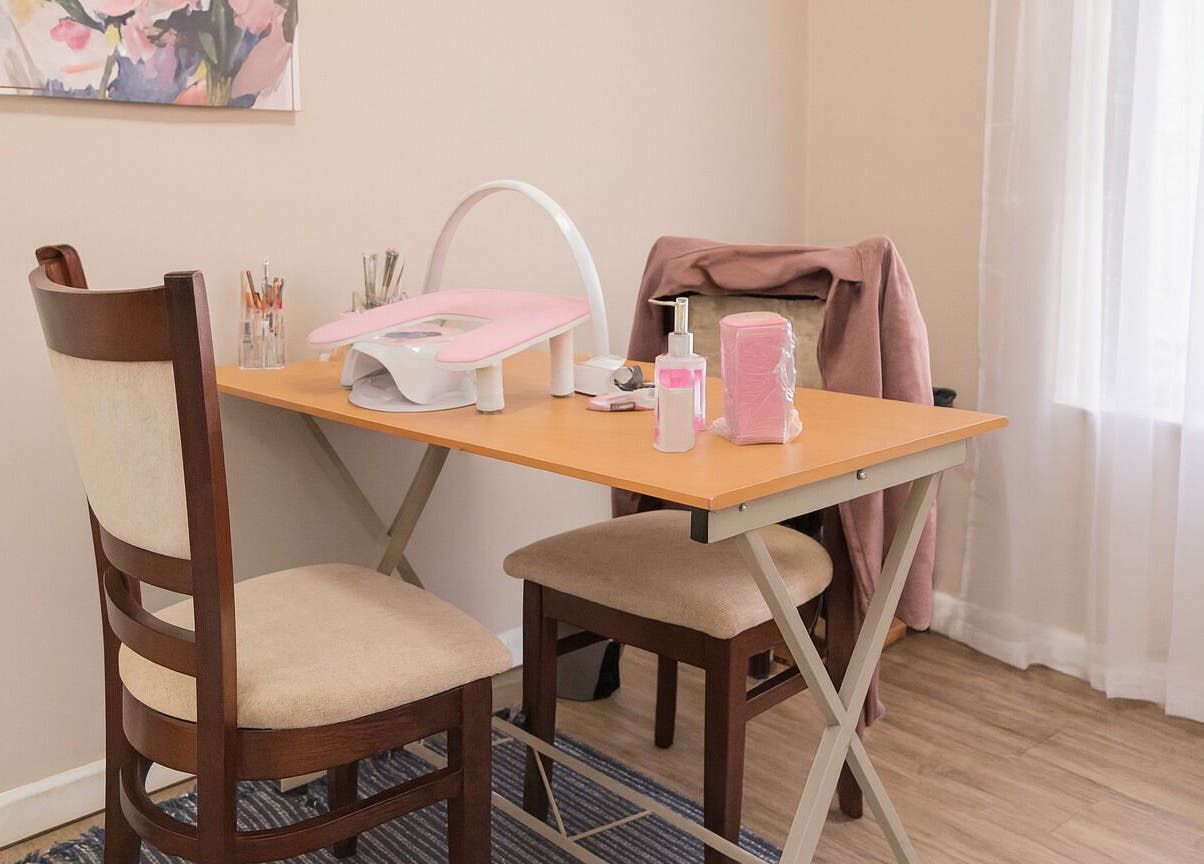 Cozy nail station at Firefly Nails, Cape Town, Western Cape, ZA with manicure tools and pink accents.