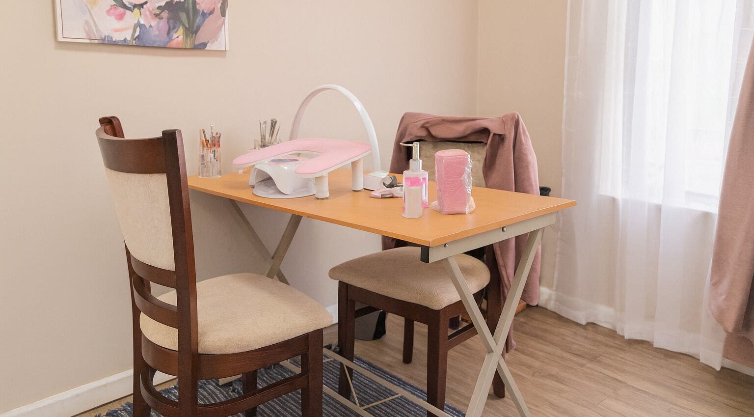Cozy nail station at Firefly Nails, Cape Town, Western Cape, ZA with manicure tools and pink accents.