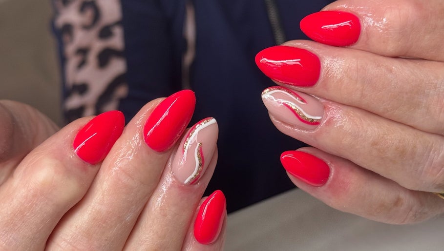 Beautiful red nails with gold accents at NailsbyHollie, Tyldesley, England, GB. Expertly crafted nail art.