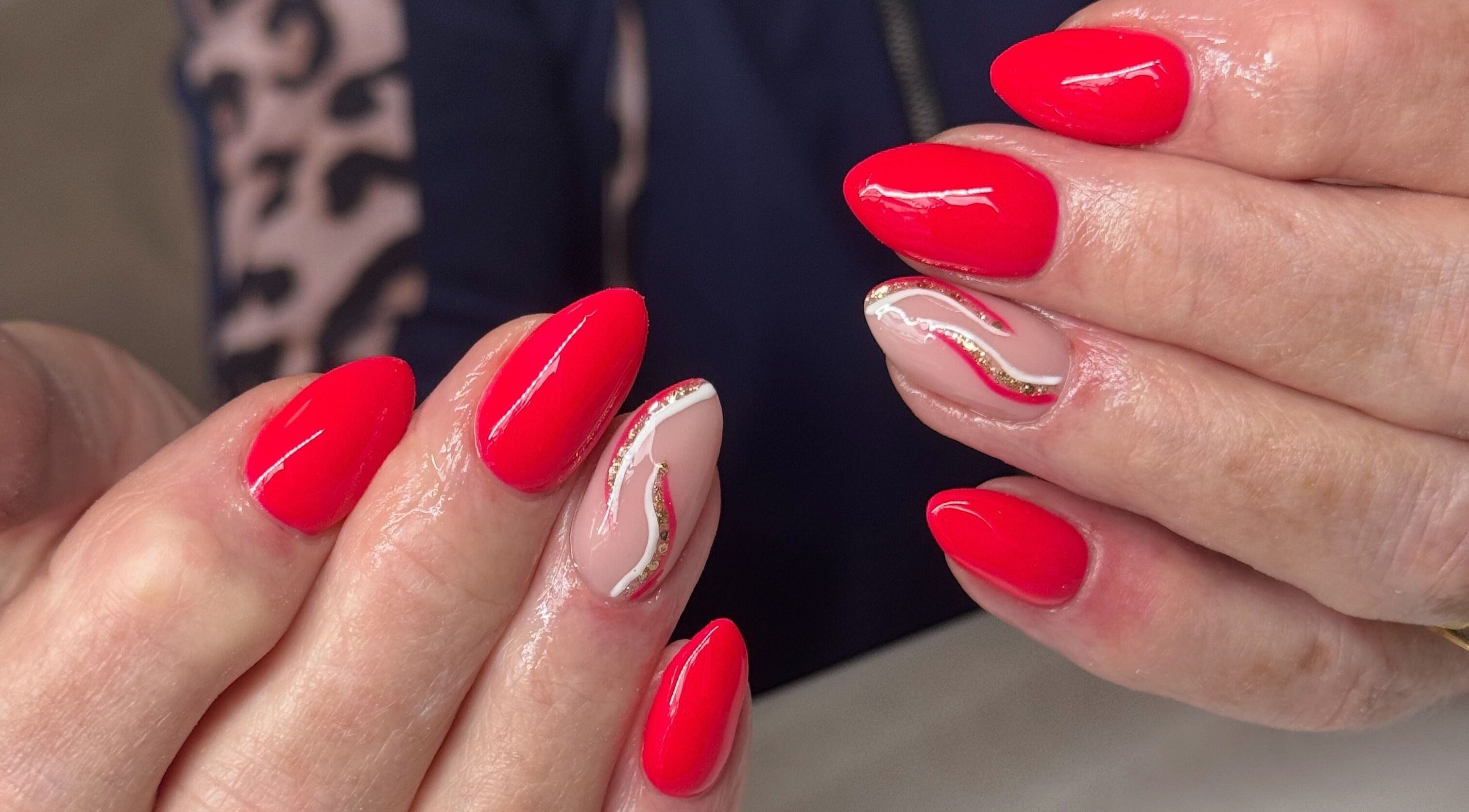 Beautiful red nails with gold accents at NailsbyHollie, Tyldesley, England, GB. Expertly crafted nail art.