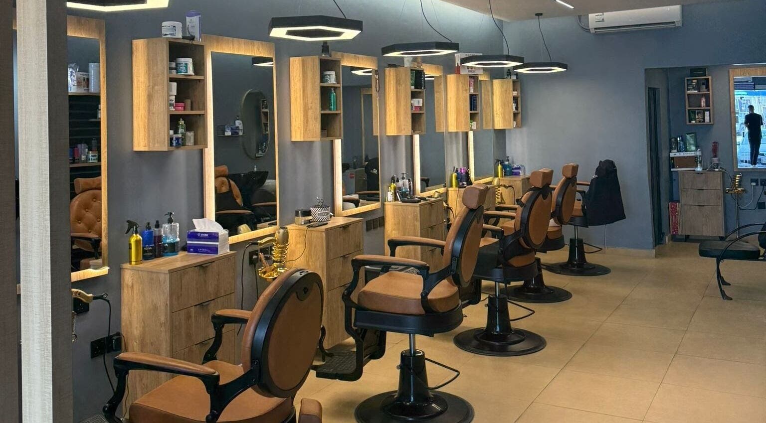 Modern salon interior at Elite Style, Riyadh, SA with stylish chairs and lighting for an upscale experience.
