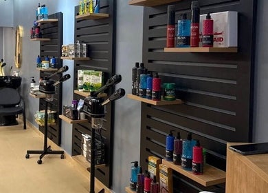 Modern salon interior of Elite Style, Riyadh, SA with stylish hair products and sleek furniture.