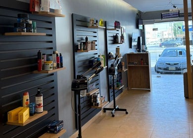Product shelves and styling equipment at Elite Style, Riyadh, SA, showcasing beauty essentials.