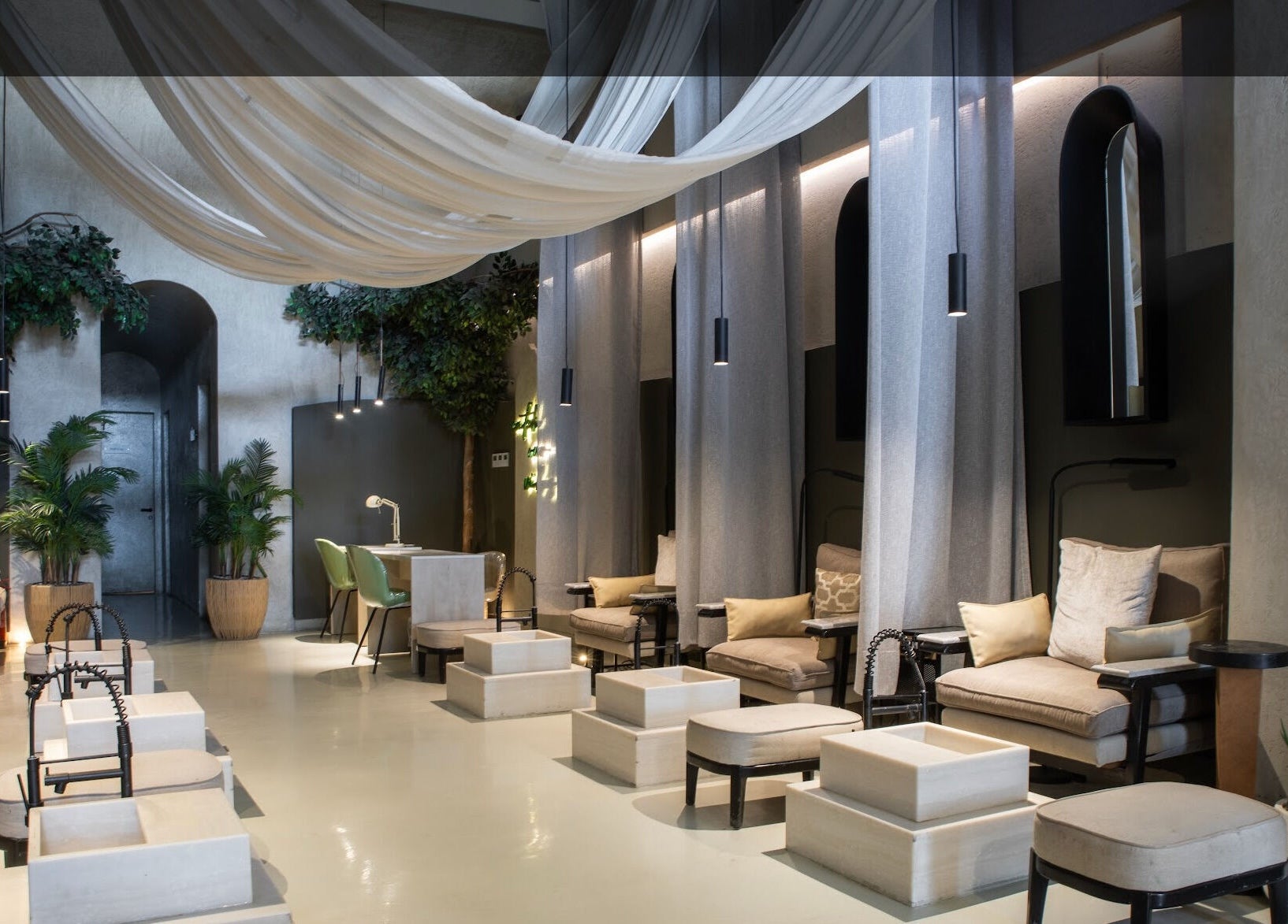 Elegant interior of Nails Aholic - Ar Rahmaniyyah in Riyadh, SA, with plush seating and ambient lighting.