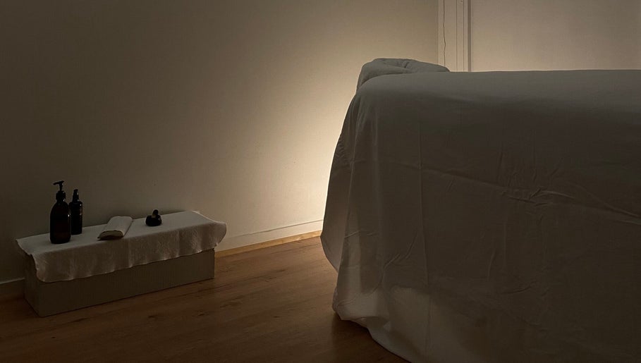 Relaxing massage room at Shkurka — Massage Studio in Byron Bay, NSW, AU, featuring a dimly lit ambiance.