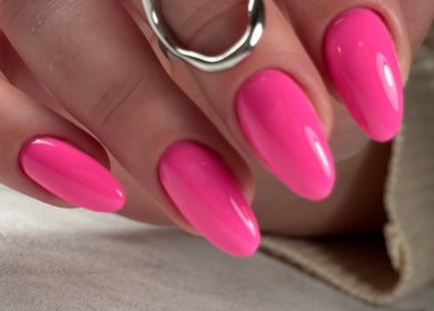 Vibrant pink manicured nails at Dangina Studio, Aurora, Illinois, US. Perfect for a stylish, bold look.