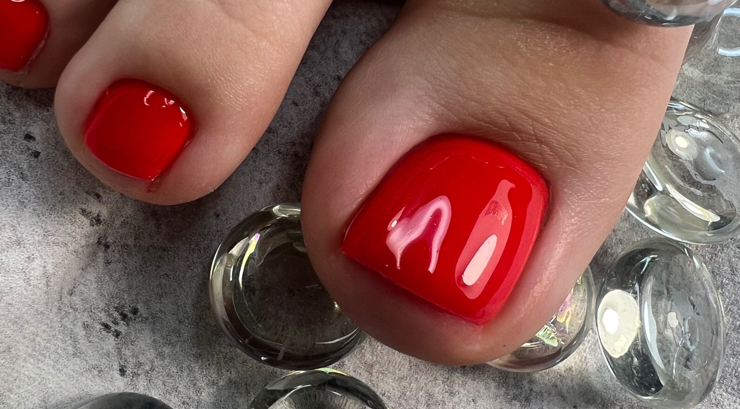 Bright red pedicure at Dangina Studio, Aurora, Illinois, US. Perfect for vibrant, stylish nails.