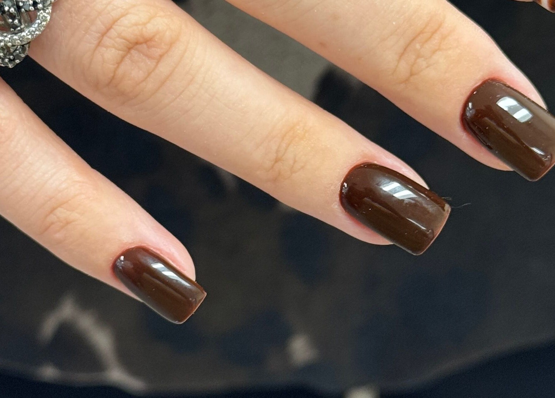 Elegant brown manicure at Dangina Studio, Aurora, Illinois, US, showcasing sophisticated nail art.