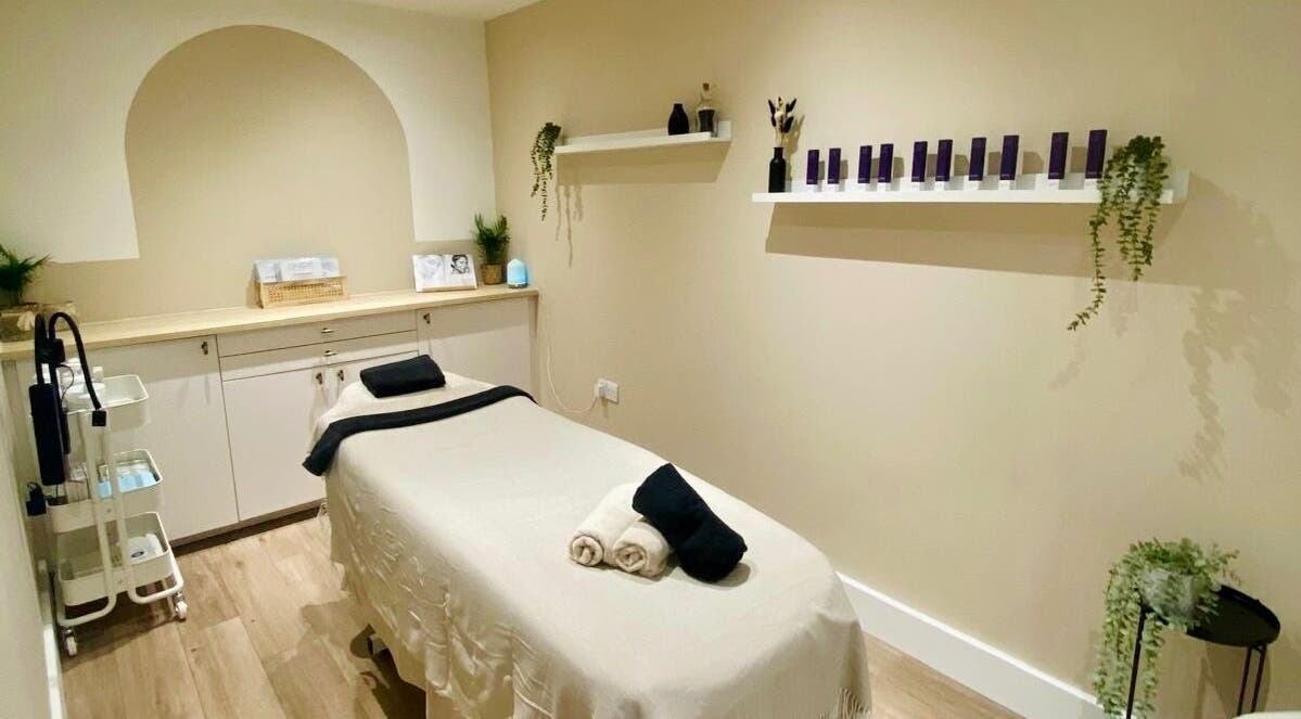 Calm treatment room at Amber Rose Cosmetics, Wombourne, England, GB, showcasing massage table and elegant decor.